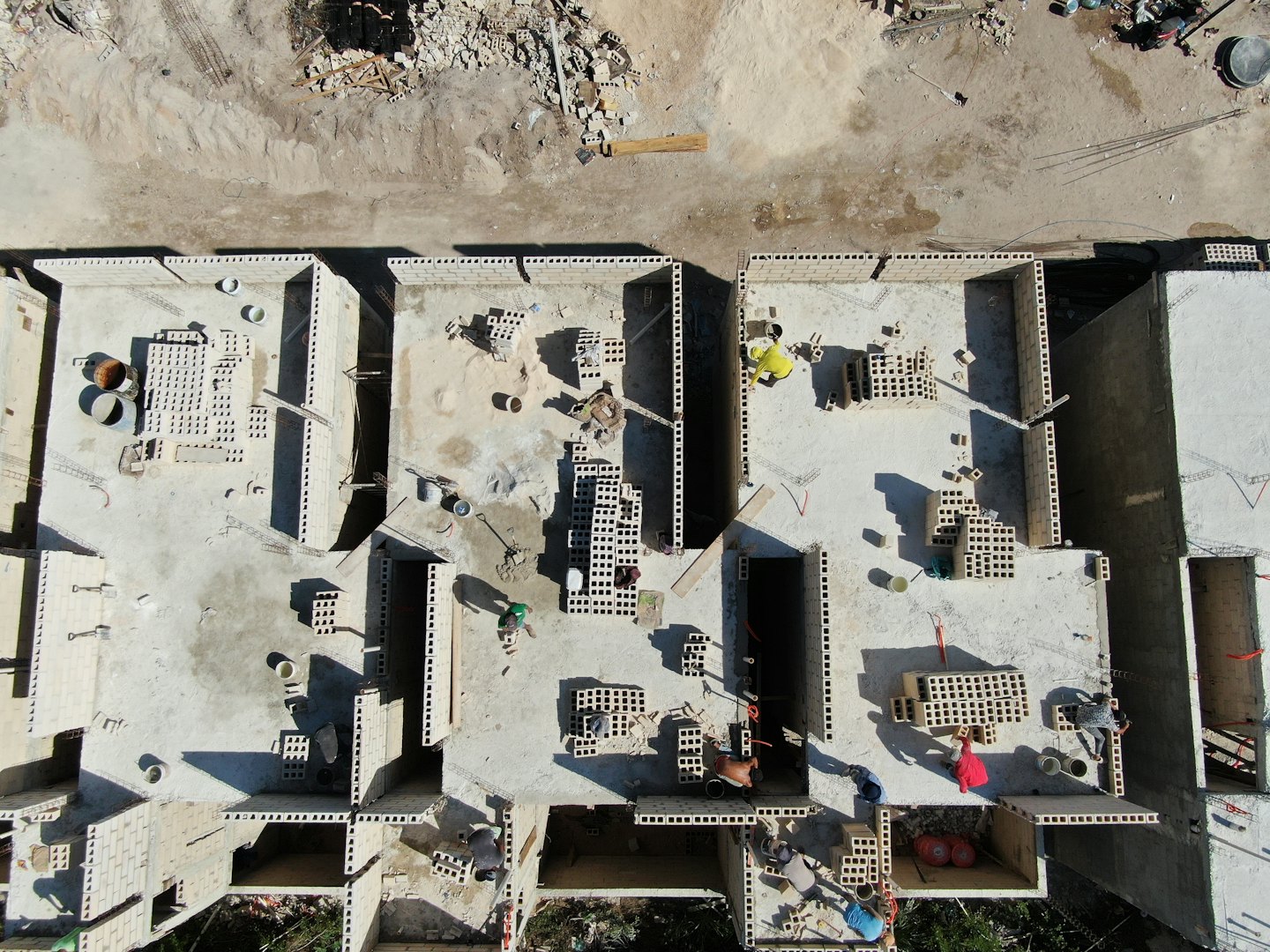 Construction workers build the foundations for several new buildings.
